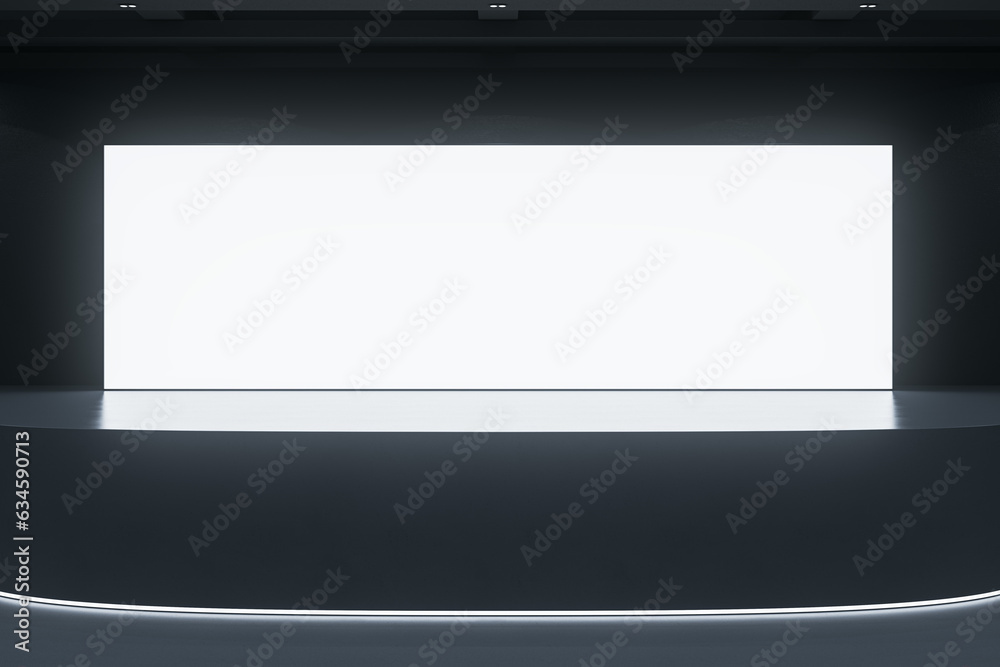 Modern exhibition hall interior with illuminated empty white mock up billboard on stage. Auditorium and advertisement concept. Modern exhibition hall interior with illuminated empty white mock up billboard on stage. Auditorium and advertisement concept.
