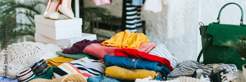 swap party for try on clothes, bags, shoes and accessories, friends change clothes, second hand and zero waste life, eco-friendly approach to consumption, clothes hanger in loft interior