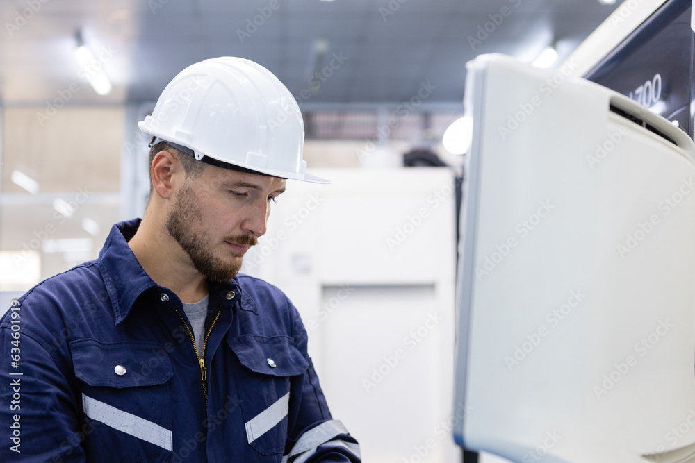 Man engineer using computer controlling cnc machine at workshop. professional male control automated machine process programming cnc machine at industry manufacturing. Man engineer using computer controlling cnc machine at workshop. professional male control automated machine process programming cnc machine at industry manufacturing.