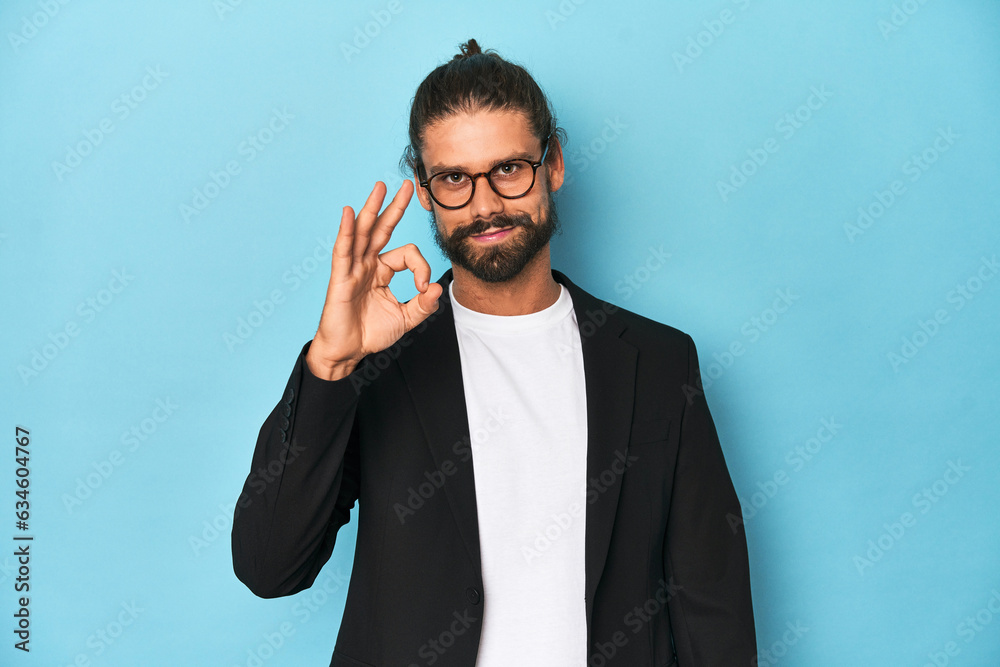 Businessman in suit with eyeglasses and beard cheerful and confident showing ok gesture. Businessman in suit with eyeglasses and beard cheerful and confident showing ok gesture.