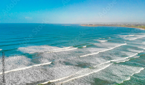 Aerial view of gentle waves along the beautiful shoreline