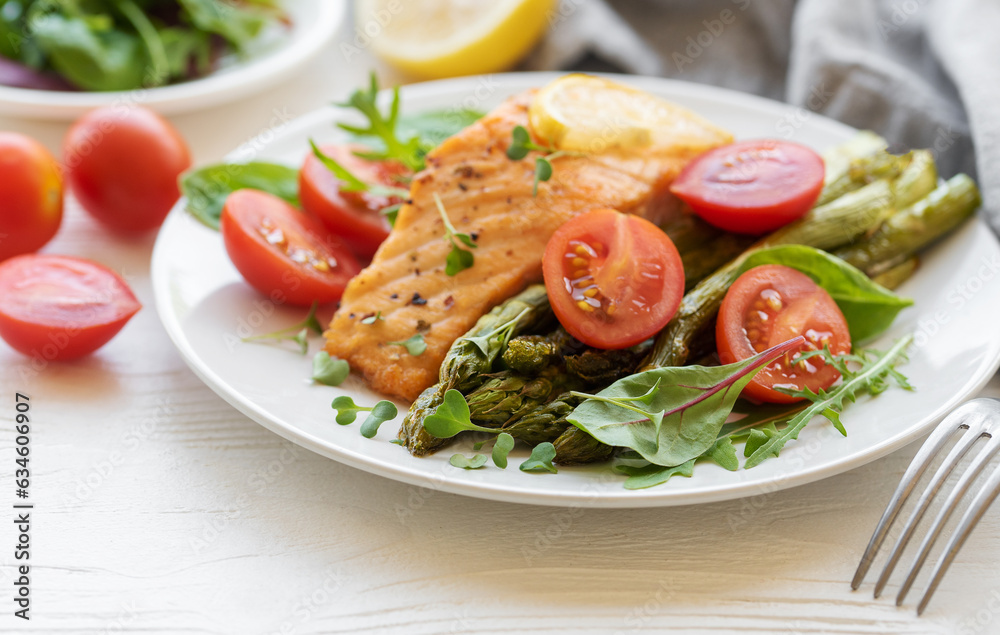 Baked Delicious salmon, green asparagus on plate Baked Delicious salmon, green asparagus on plate