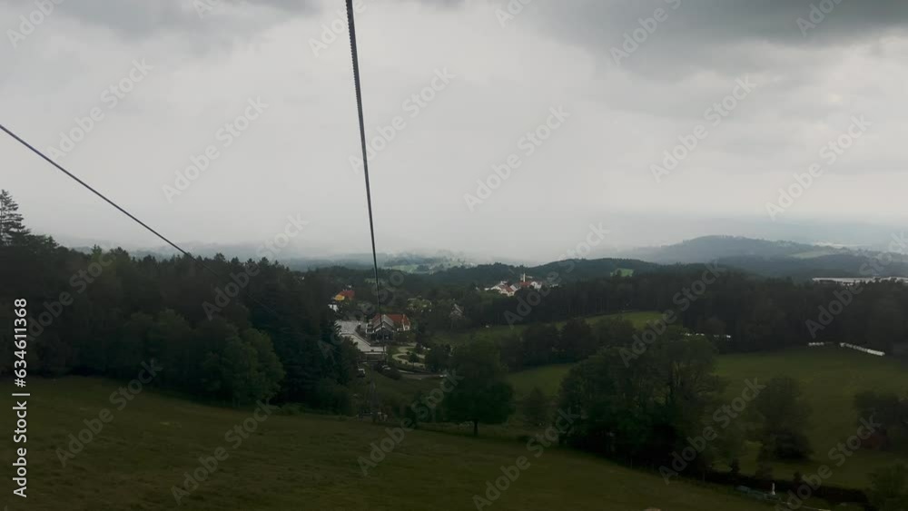 Ascending gondola-ski lift ride in Austria at a mountain resort with fog in the background Ascending gondola-ski lift ride in Austria at a mountain resort with fog in the background