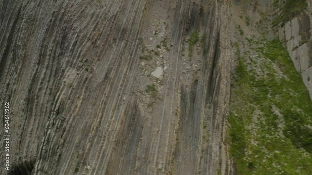 Aerial dolly across flysch geologic shale patterned cliffs at itzurun Aerial dolly across flysch geologic shale patterned cliffs at itzurun