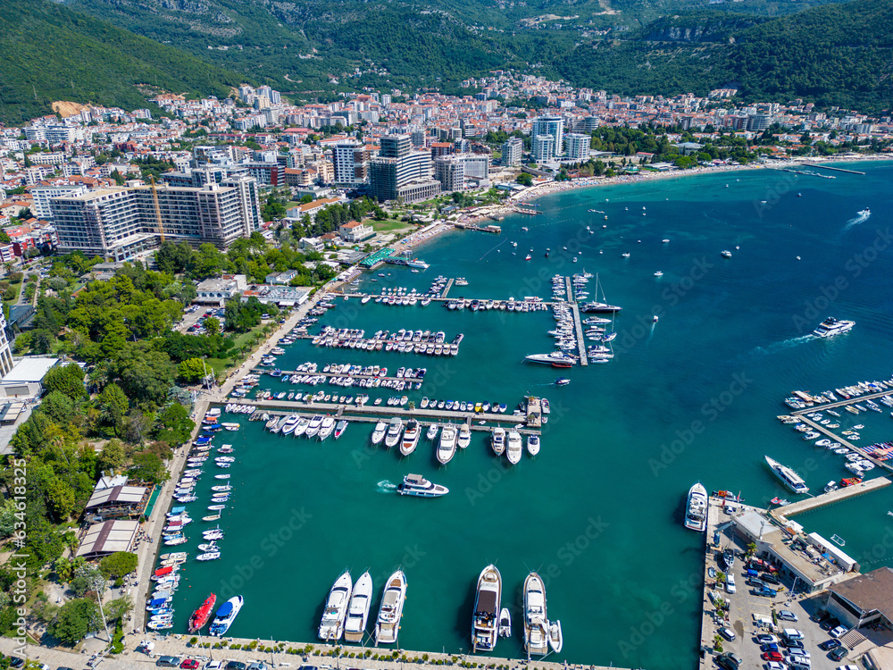 City of Budva in Montenegro. Aerial view of Port and Beach Greco. Coastline of the Adriatic Sea at summer time. Natural landscapes of Montenegro. Balkans. Europe.