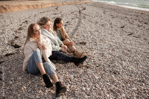 Happy multicultural friends have fun , laugh and hug each other in the sea. People walking together, the beautiful plus size woman with  girls are smiling.