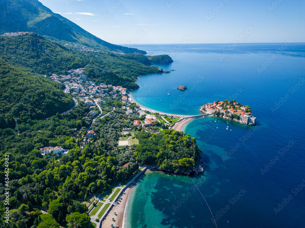 Island of Sveti Stefan near Budva in Montenegro. Beaches and coastline of the Adriatic Sea at summer time. Natural landscapes of Montenegro. Balkans. Europe.