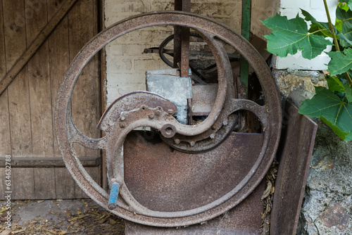 Old manual straw cutter on farm in overcast weather