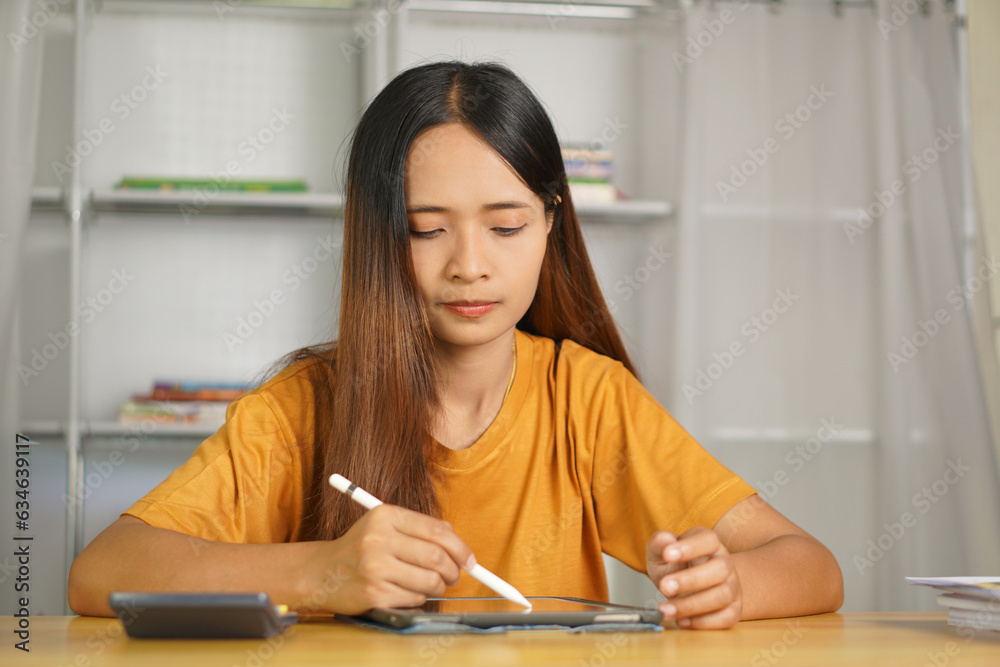 Asian woman working from home Happy from watching the profits through the computer. Asian woman working from home Happy from watching the profits through the computer.