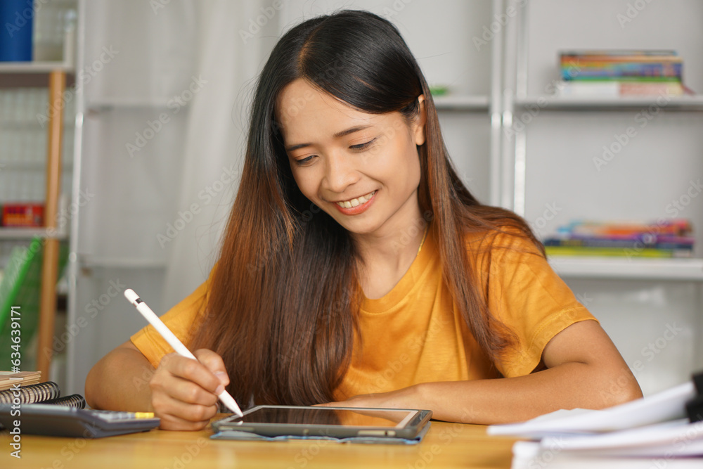 Asian woman working from home Happy from watching the profits through the computer. Asian woman working from home Happy from watching the profits through the computer.
