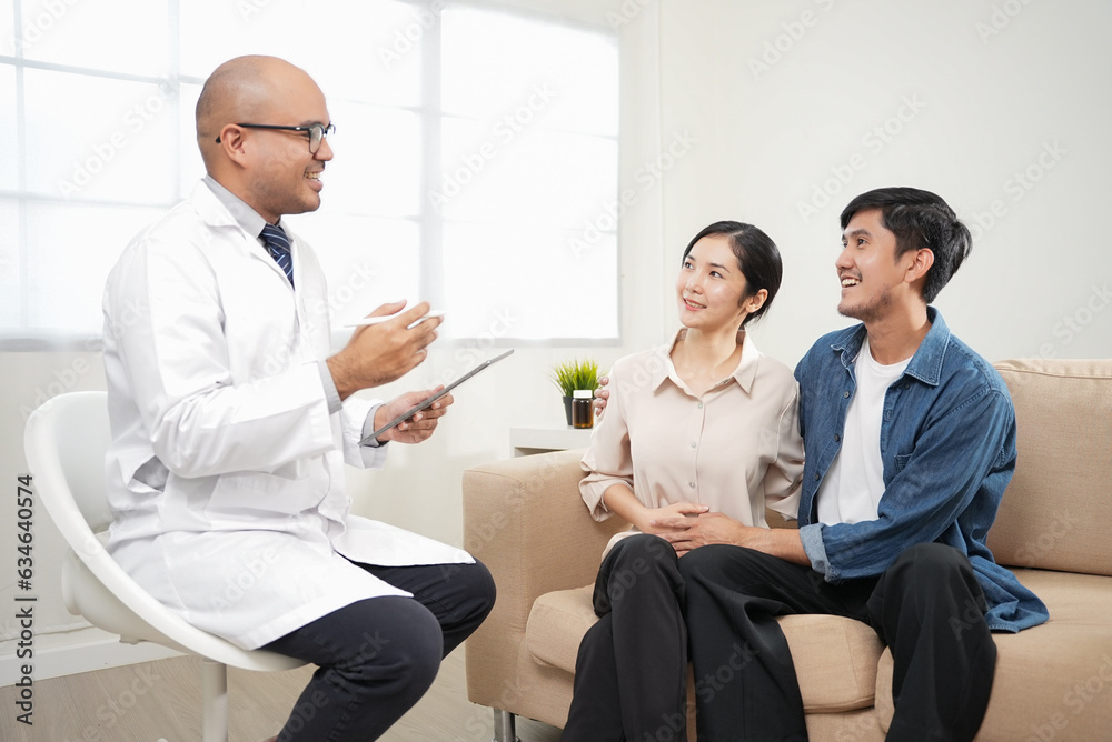 Male doctor giving test result to asian couple patient with tablet. They feeling happy and holding hand together when received good news from the doctor in medical office, hospital, clinic or home. Male doctor giving test result to asian couple patient with tablet. They feeling happy and holding hand together when received good news from the doctor in medical office, hospital, clinic or home.