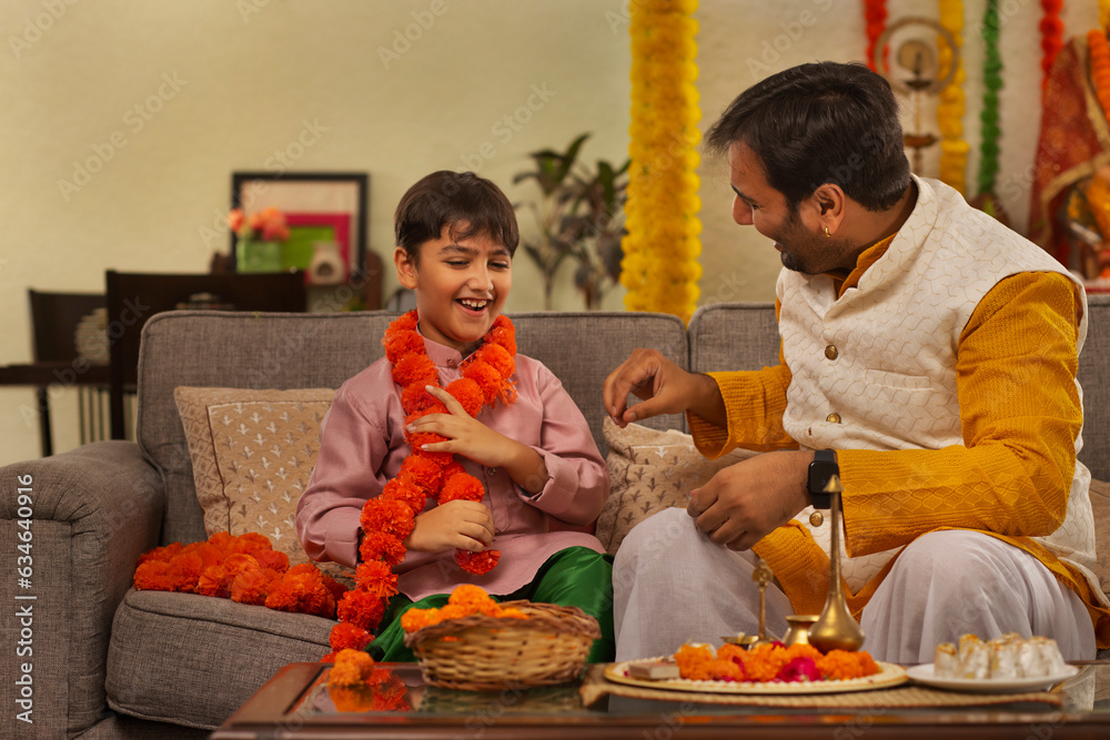 Father and son enjoying a conversation during  Ganesh Chaturthi a festival celebrated in Maharashtra ( Western India)