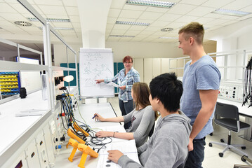 Group of young people in technical vocational training with teacher