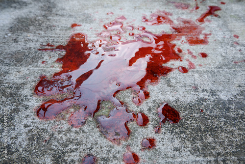 blood spills on the cement floor. concept photo illustration of murder and blood vomiting disease photo