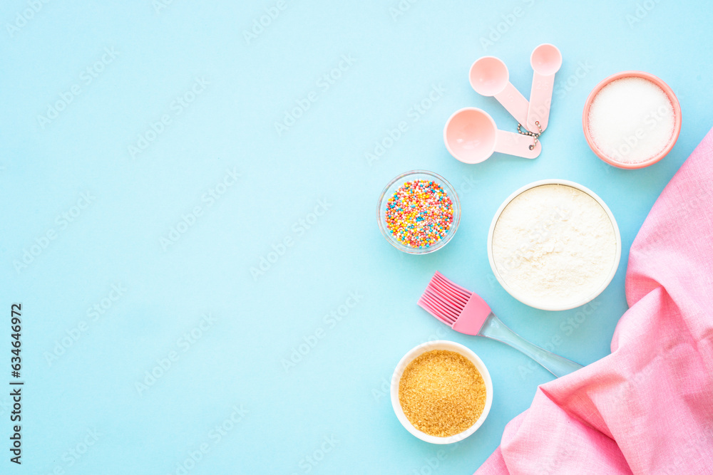 Food baking background on blue. Ingredients for cooking, flour, sugar, eggs. Flat lay with copy space. Food baking background on blue. Ingredients for cooking, flour, sugar, eggs. Flat lay with copy space.