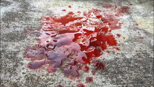 blood spills on the cement floor. concept photo illustration of murder and blood vomiting disease photo