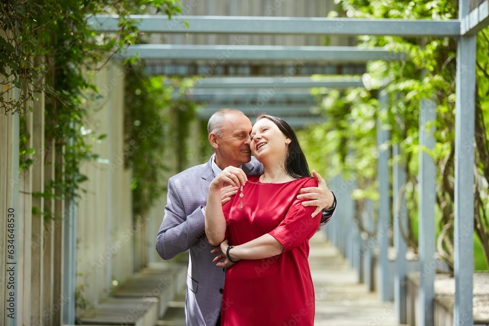 Fototapeta premium Beautiful older adult married couple in the park. Love and feelings in adults