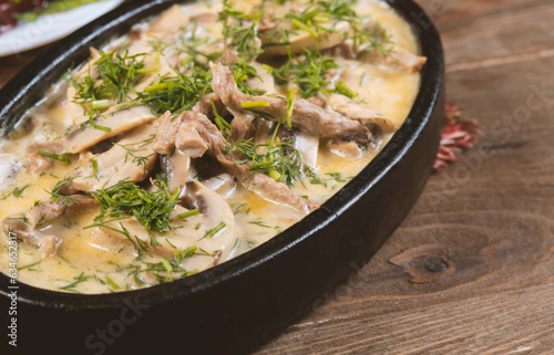 Beef and mushroom stew in a creamy sauce served in a pan