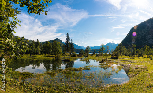 Überflutete Weidefläche in den Alpen mit Bergen im Hintergrund photo