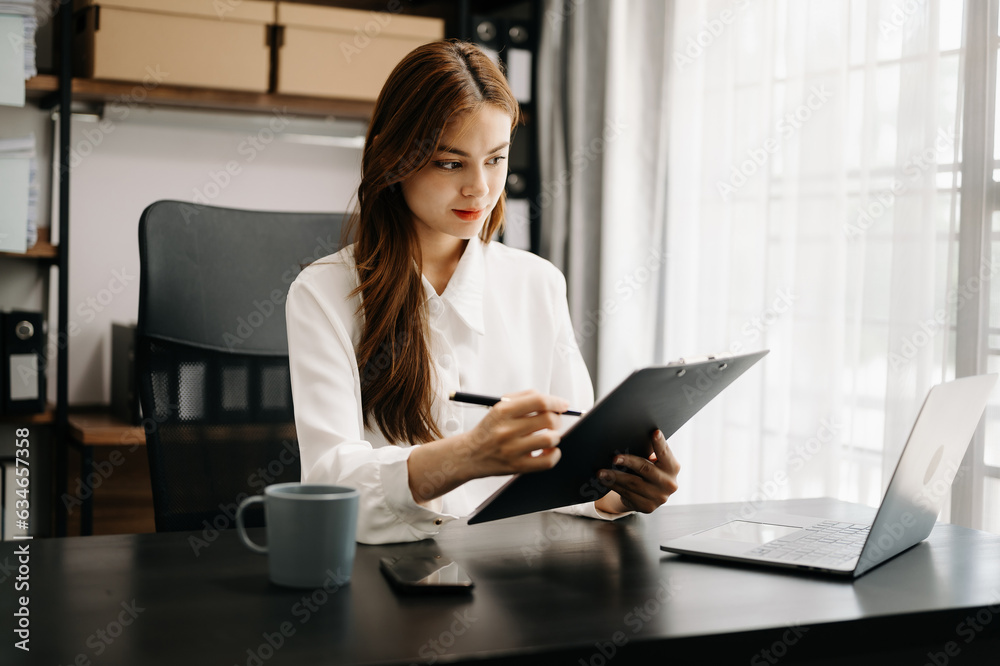 Confident business expert attractive smiling young woman holding digital tablet on desk in creative office. Confident business expert attractive smiling young woman holding digital tablet on desk in creative office.