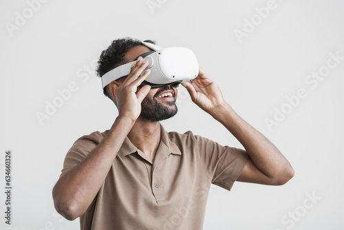 Young man using virtual reality headset isolated on gray background, VR, future gadgets, technology, virtual event, education, study, learning, video game concept