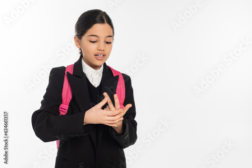 brunette schoolgirl counting on fingers isolated on white, student in uniform, education, smart