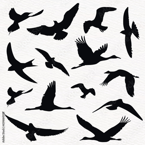 Flock of flying birds in a set of vector silhouettes
