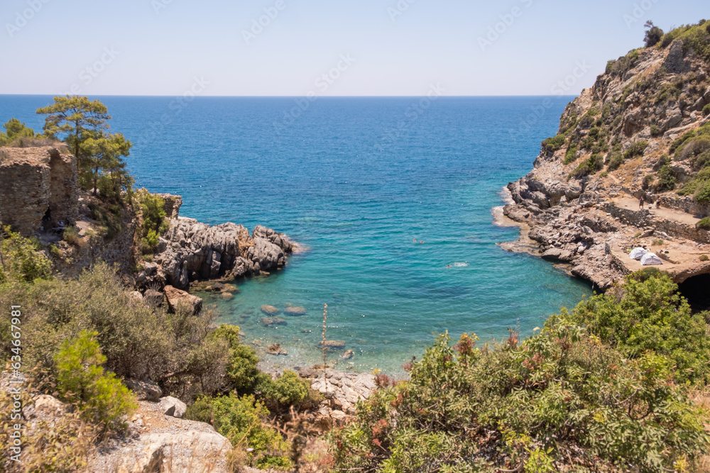 View to Mediterranean sea from the coast. Rocky sea coast covered by pines in Alanya, Turkey.