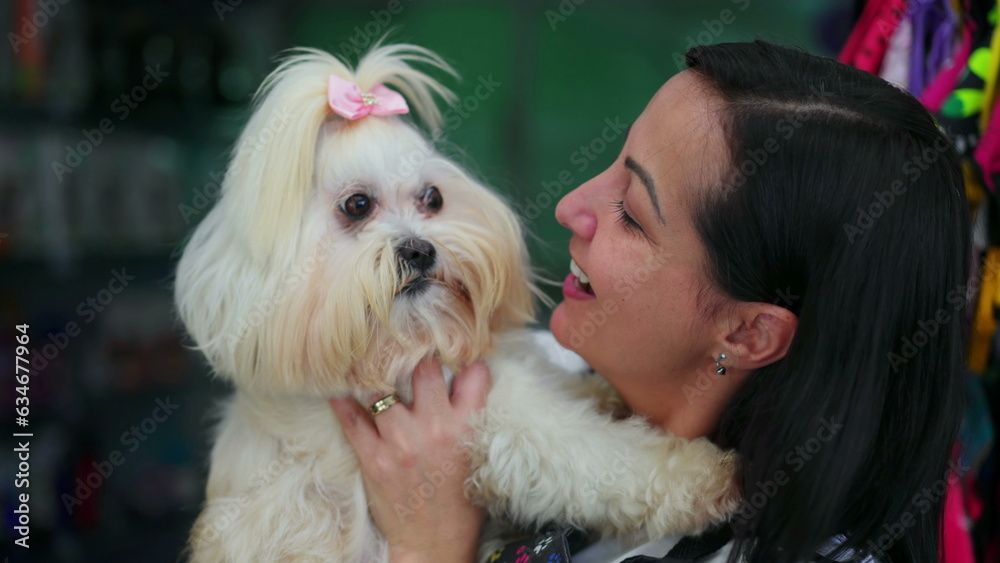 Happy woman embracing her Small Dog. Candid moment of canine affection and care for Shih-Tzu breed Happy woman embracing her Small Dog. Candid moment of canine affection and care for Shih-Tzu breed