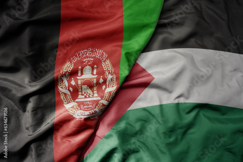 big waving realistic national colorful flag of afghanistan and national flag of palestine .