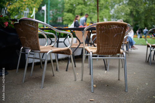 two chairs next to a table in outdoors cafe