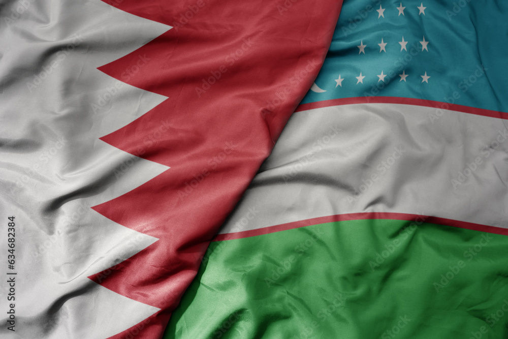 Obraz premium big waving realistic national colorful flag of bahrain and national flag of uzbekistan .