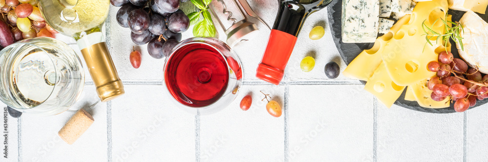 Wine set with Craft cheese assortment at white tile background. Long banner format. Wine set with Craft cheese assortment at white tile background. Long banner format.