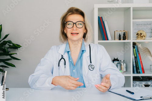 Headshot of middle aged female doctor talking with client online on computer, female nurse talking to sick patient on video call, using laptop. Telemedicine concept. Online remote medical appointment