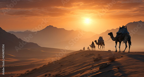 Camels traveling in the middle of the desert with sky in the sunset orange background.