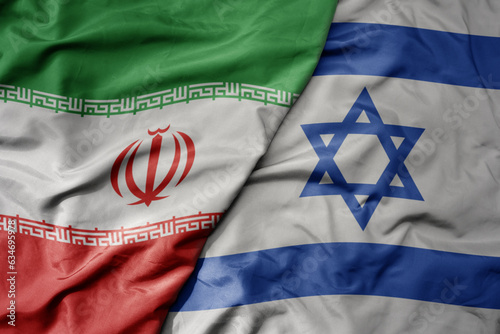 big waving realistic national colorful flag of iran and national flag of israel .