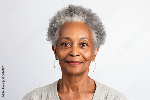 Close-up portrait of an elderly African American woman with gray hair, studio shot, isolated on white background. Generative AI. © Nico Vincentini