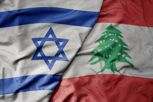 big waving realistic national colorful flag of israel and national flag of lebanon .