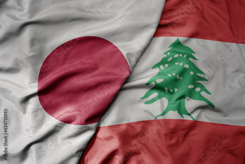 big waving realistic national colorful flag of japan and national flag of lebanon . photo