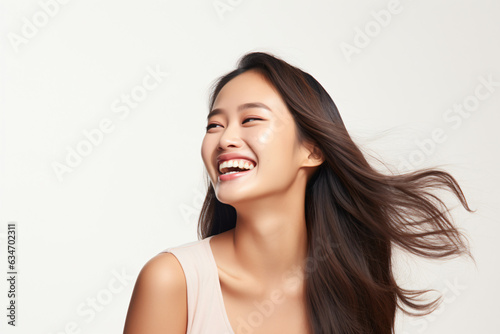 A close-up shot of a radiant young Asian woman, smiling with impeccable teeth. Designed for a dental promotion. With a white background. Crafted following the rule of thirds. Generative AI.