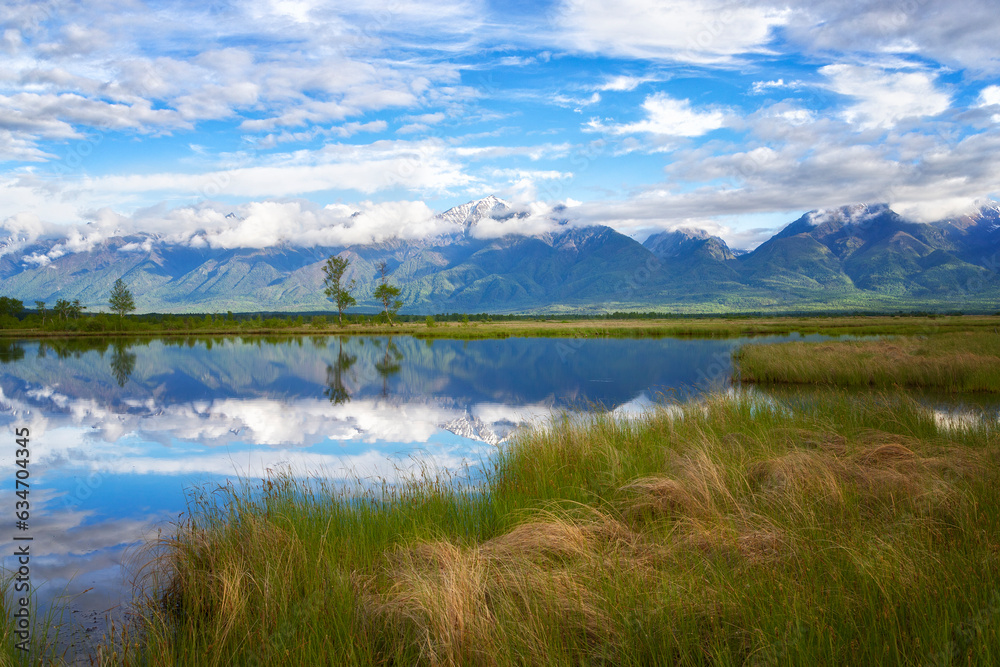 Russia. Landscape with mountains reflecting in the water on summer day. Buryatia, Tunkinskaya valley Russia. Landscape with mountains reflecting in the water on summer day. Buryatia, Tunkinskaya valley