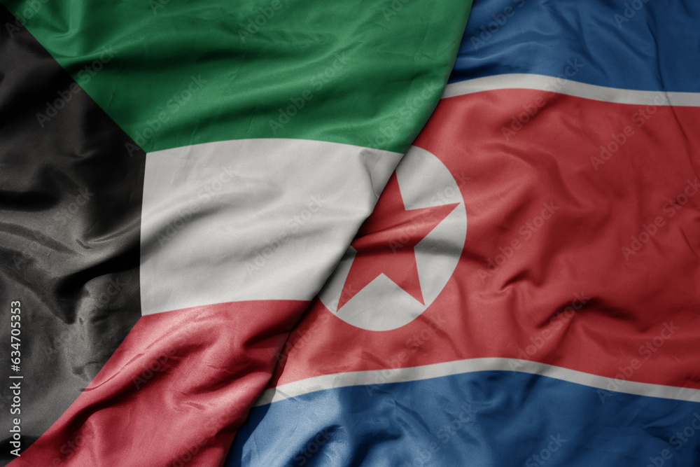 big waving realistic national colorful flag of kuwait and national flag of north korea .