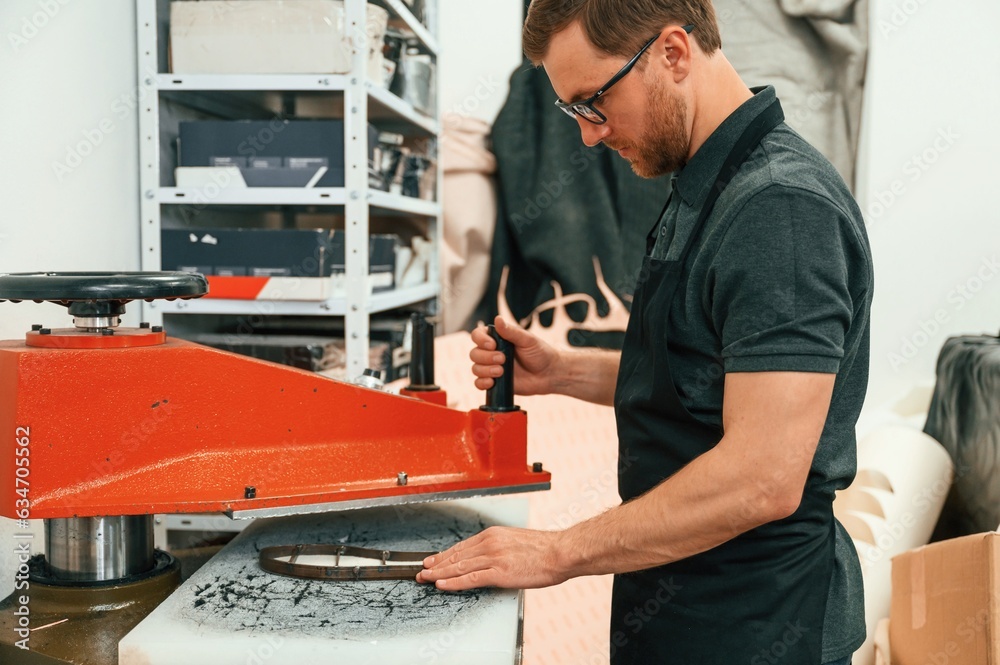 Processes the sole. Technician working with prosthesis in modern laboratory Processes the sole. Technician working with prosthesis in modern laboratory