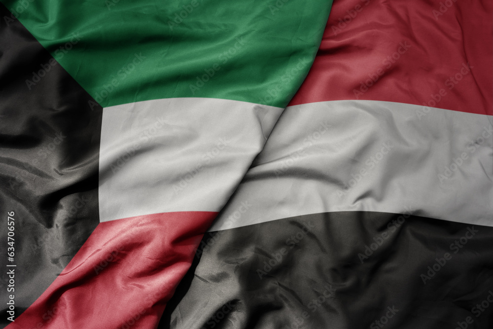 big waving realistic national colorful flag of kuwait and national flag of yemen .