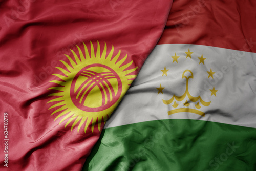Obraz na plátně big waving realistic national colorful flag of kyrgyzstan and national flag of tajikistan