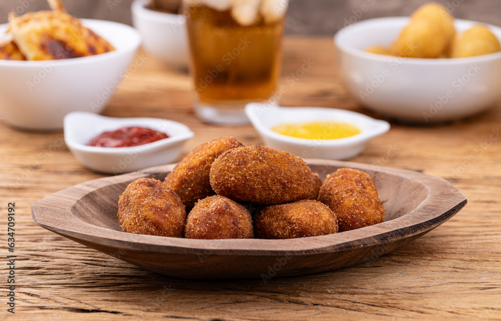 Typical brazilian meat filled snack on a plate with soda glass, ketchup and mustard Typical brazilian meat filled snack on a plate with soda glass, ketchup and mustard