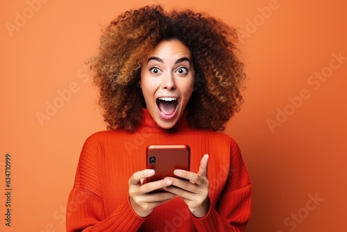Slika na platnu Young happy lucky woman student feeling excited winner looking at cellphone usin