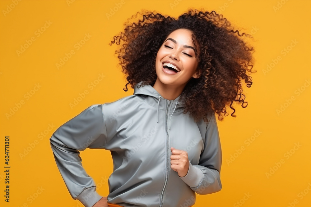 Pretty African American woman in sports clothing doing some fun dance moves Pretty African American woman in sports clothing doing some fun dance moves