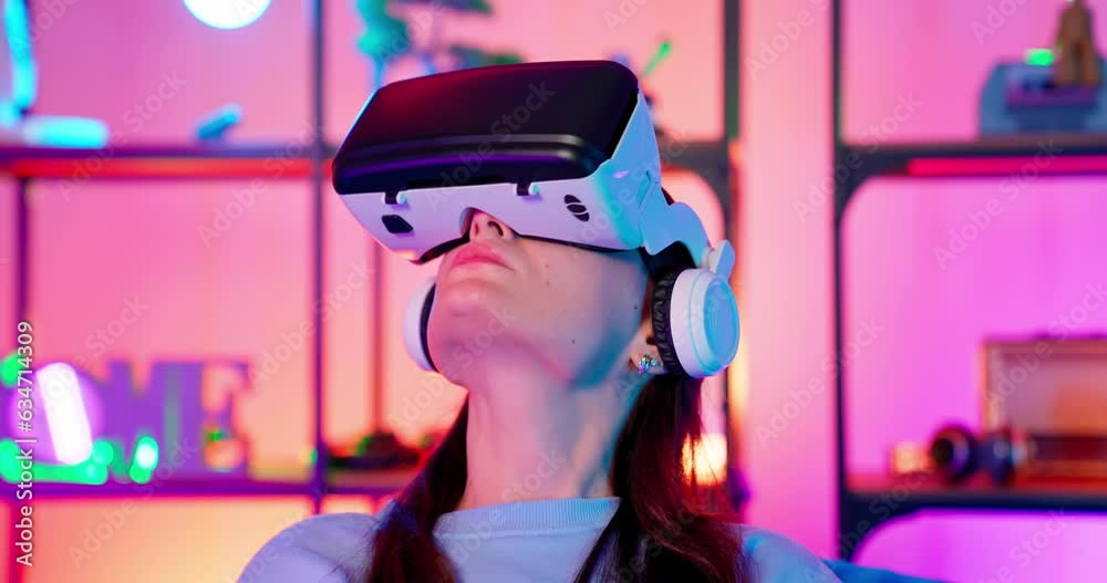 Gamers play in a room with RGB lighting. Game with vr glasses. Joystick game. Handsome guy and girl play computer games. Virtual reality glasses. Gamers play in a room with RGB lighting. Game with vr glasses. Joystick game. Handsome guy and girl play computer games. Virtual reality glasses.