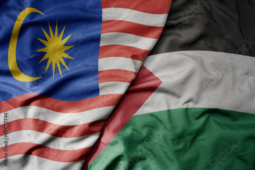 big waving realistic national colorful flag of malaysia and national flag of palestine .